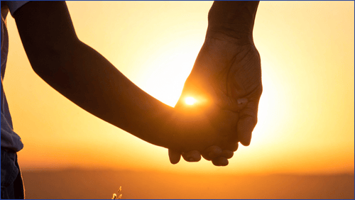 A parent holding a child's hand