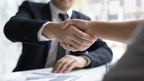 People shaking hands at job interview. 