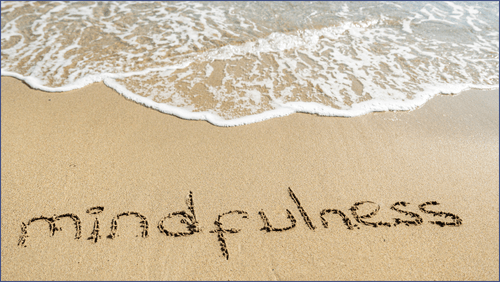 Tide coming in and Mindfulness spelt on the sand