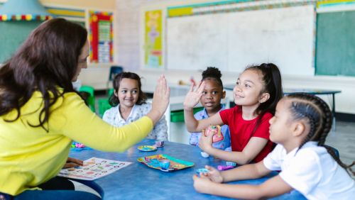 Teacher with class and high fiving student