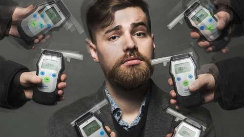 Oliver Kilmartin surrounded by breathalysers