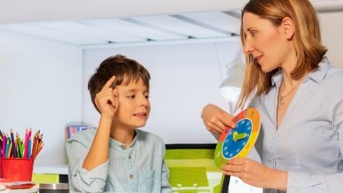 teacher doing colour co-ordination with child 