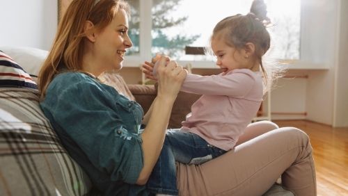 mother talking and playing with her child.