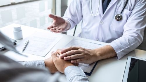 doctor holding patients hand. 