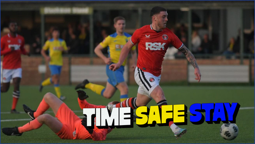 Man in a red jersey kicking a football
