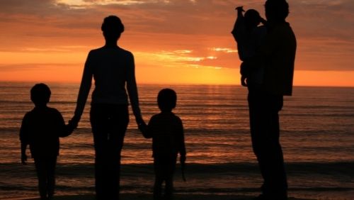 family looking at sunset.