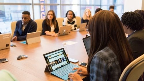 employees having a meeting around a board room table.