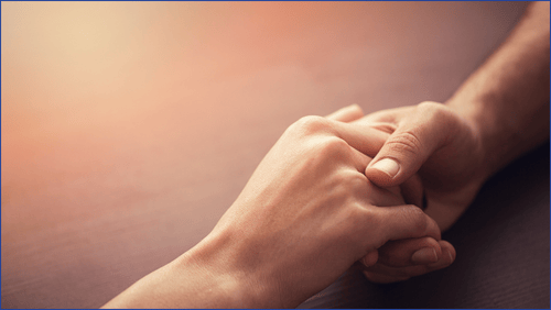 Two hands holding each other