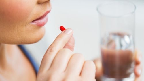 woman taking medication.