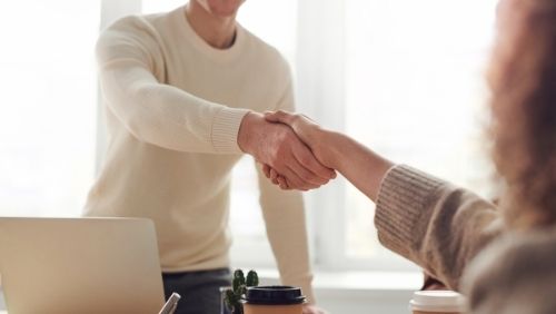 two people shaking hands prior to a job interview.