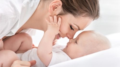 mother playing with her baby.