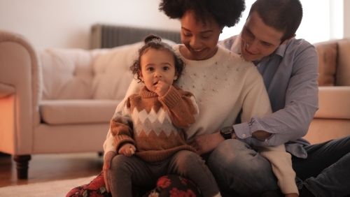 parents embracing their child.