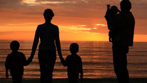 family looking at sunset.