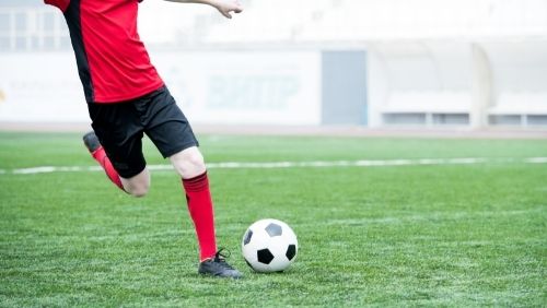 person about to kick a ball.