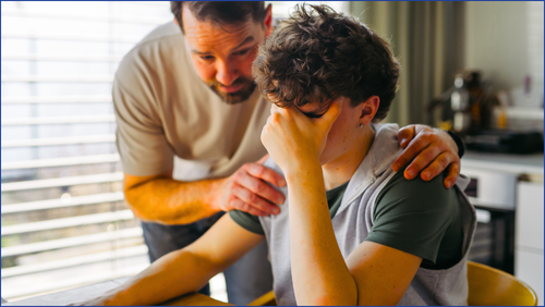 One man comforting another man who appears to be in crisis