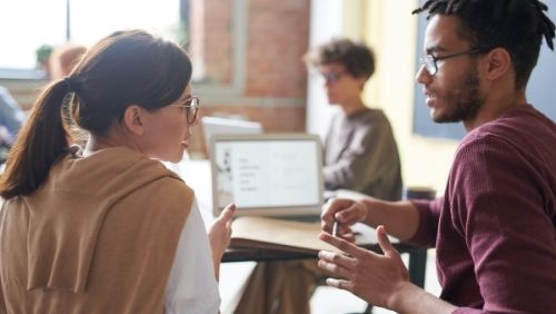 Image of two people in conversation.