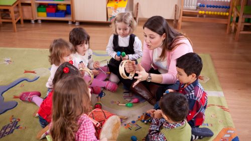 Teacher talking to young children