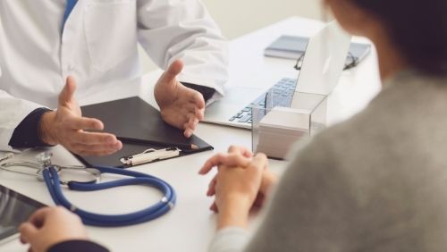 a Doctor talking to their patient.