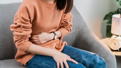 woman nursing her stomach.