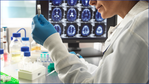 A person holding a test tube in a lab