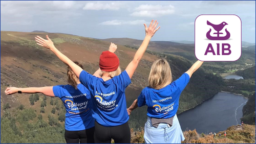 EI Volunteers on a mountain top and the AIB logo to the RHS of the pic