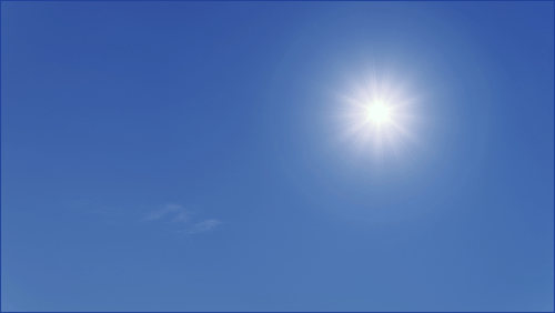 Sun shining in a blue sky
