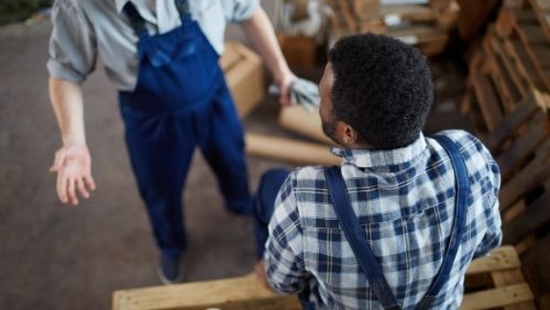 Image of two men in conversation at work.