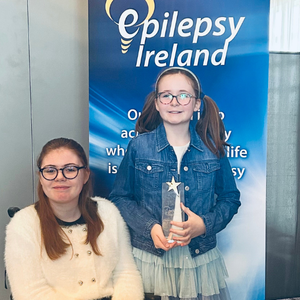 Rebecca with her little sister Emma holding her award