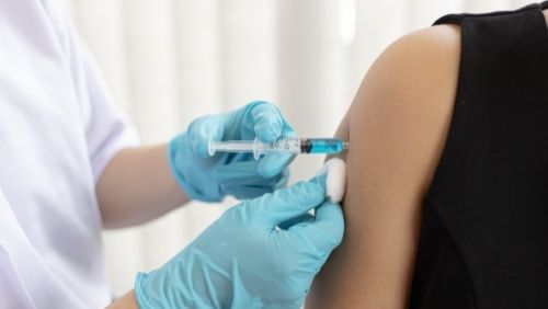 Image of a person being injected with vaccine