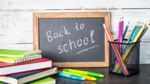 Blackboard and school materials displaying back to school