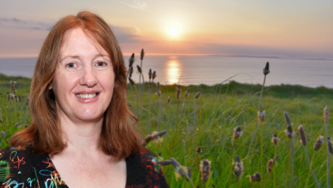 Cliona Molloy with background of sunset over peaceful sea & field