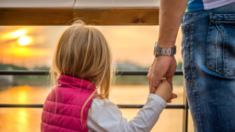 child holding father's hand