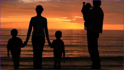family looking at sunset.