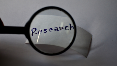 magnifying glass over written word research