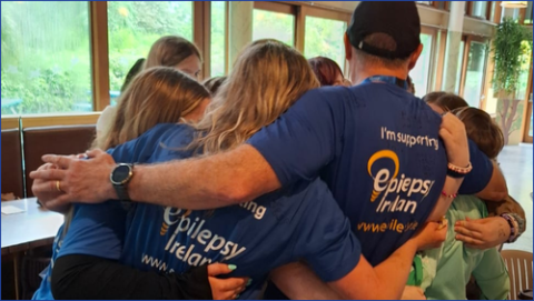 People at EI event having a group Hug