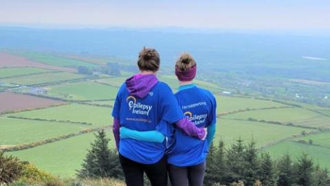 Two EI Volunteers on top of hill looking over scenery